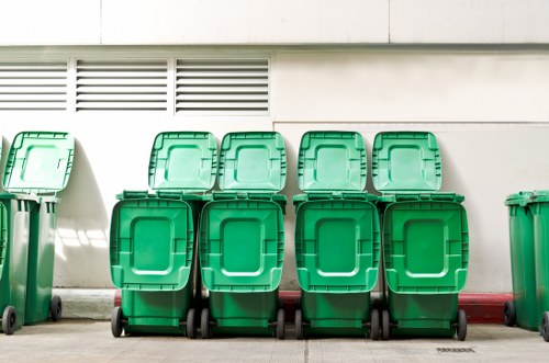 Workers loading rubbish into a skip