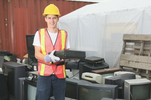 Customer loading a skip with waste in a Hampstead neighborhood