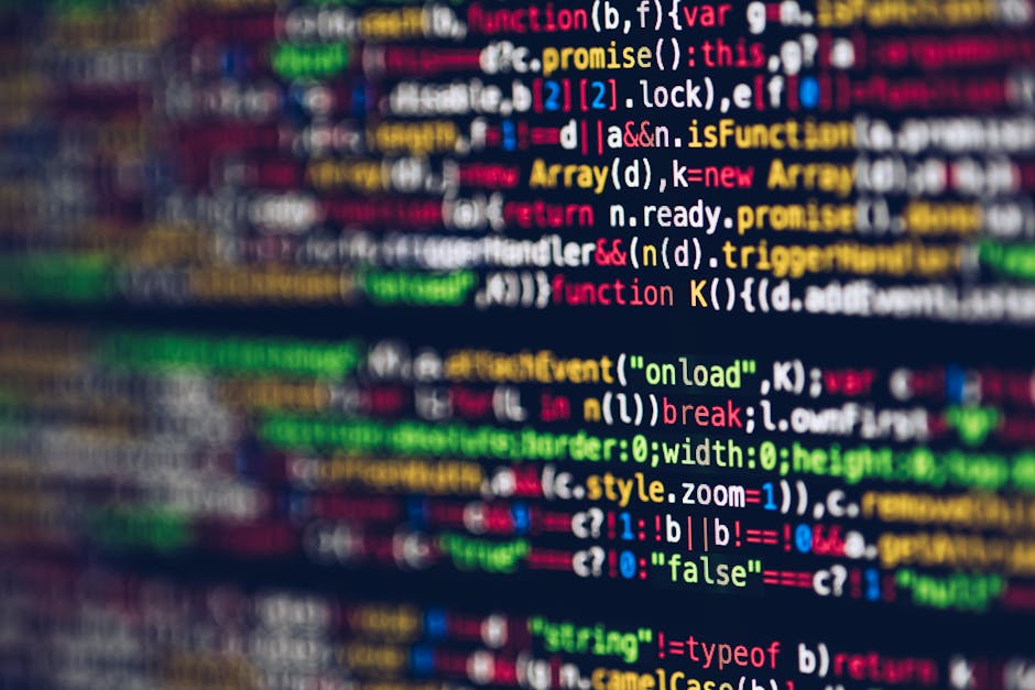 A close-up photograph of a computer screen displaying lines of computer code with syntax highlighting. The code features various keywords, functions, and variables shown in multiple colours such as re